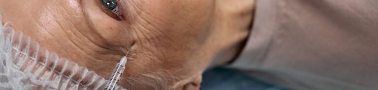 A senior woman undergoes a cosmetic injection procedure in a medical facility.